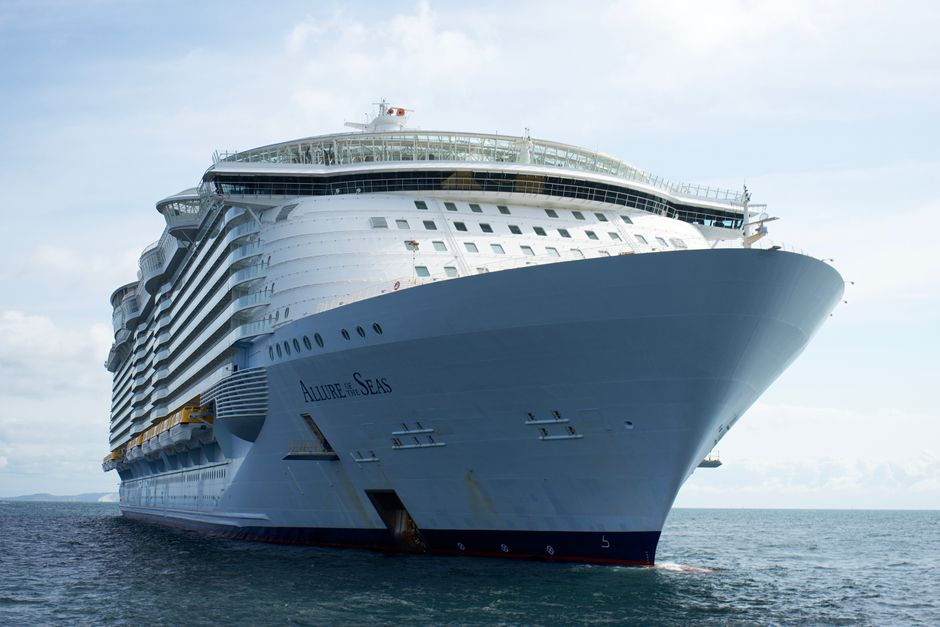 A majestic view of the Allure of the Seas cruise ship sailing on the ocean under a clear sky.