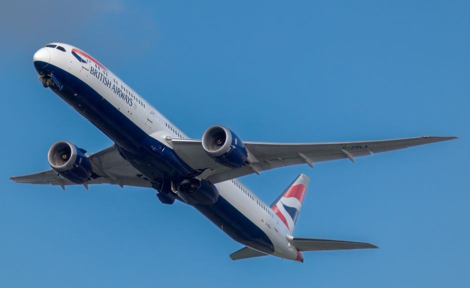 British Airways airplane in flight against a clear blue sky, showcasing aviation excellence.